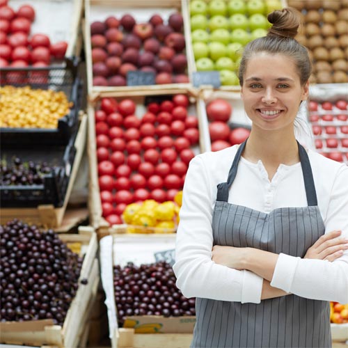 Woman at a fruit stand. Phase One Financial Group helps you compare apples to oranges to mangoes and more.