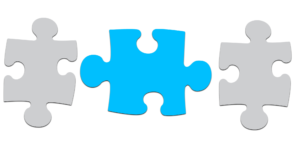 two gray puzzle pieces with a blue puzzle piece between them